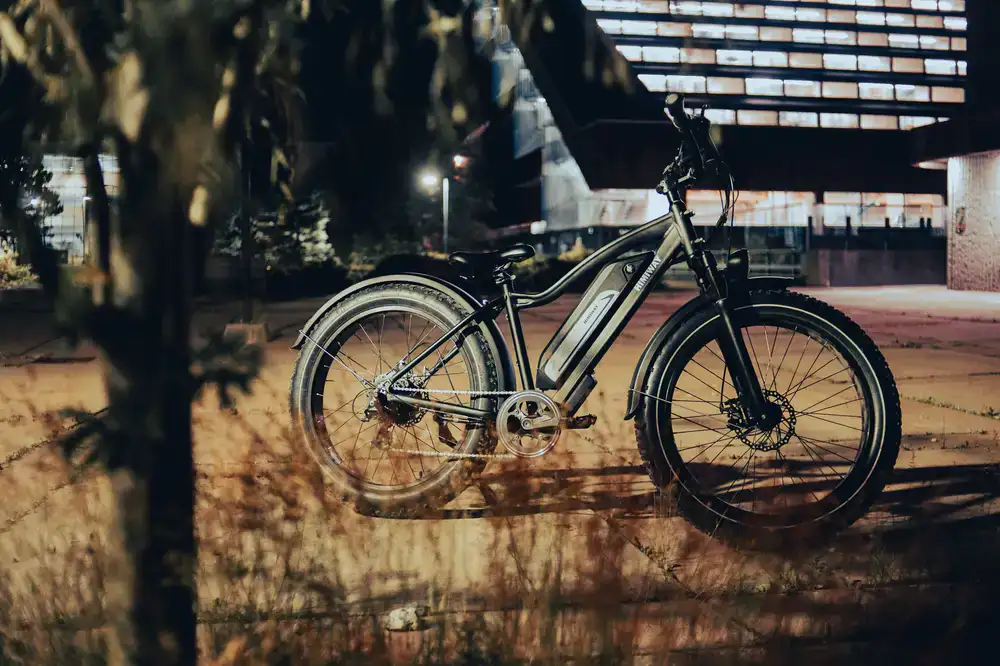 Modern electric bicycle parked by an olive grove