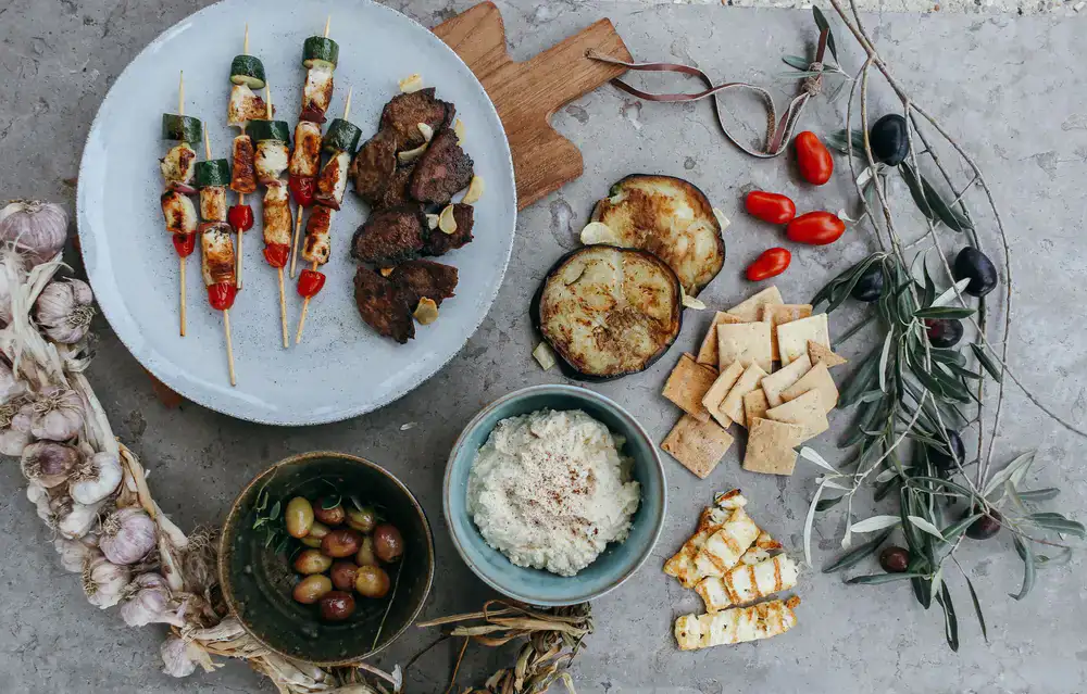 Rustic outdoor lunch spread set under the shade of mature olive branches