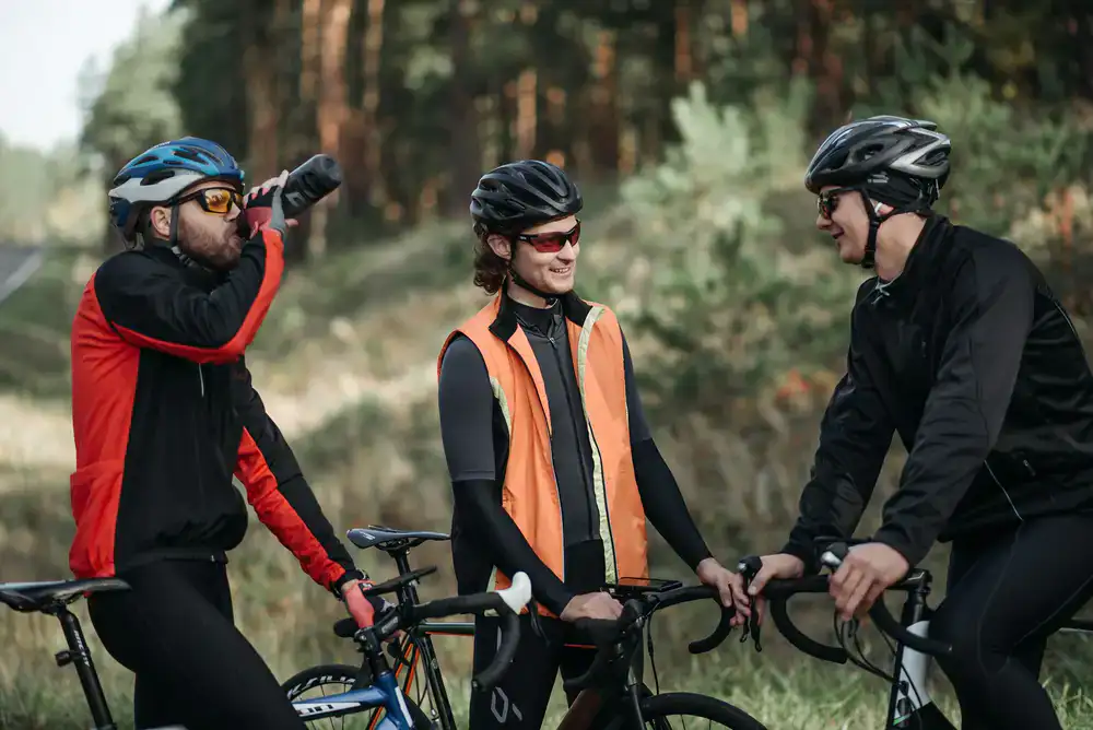 Group of happy cyclists pausing their ride to take photos of the landscape