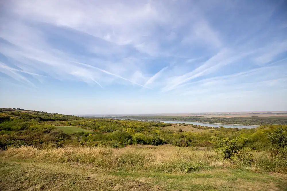 Wide panoramic view of rolling hills under a bright blue sky