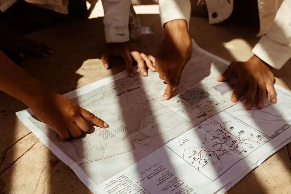 Guide pointing at a scenic route map with a group